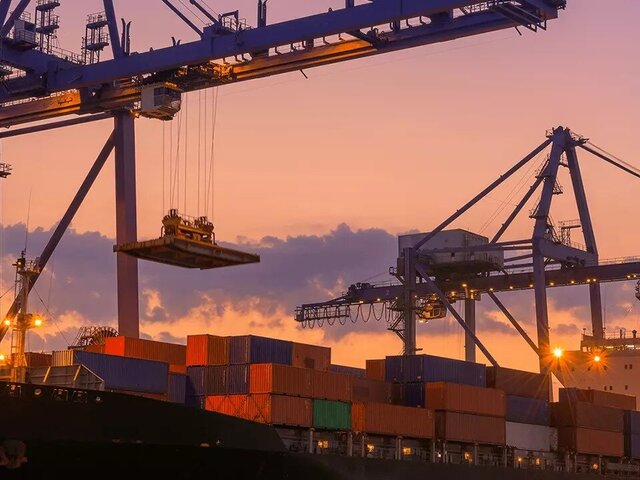 Containership in port at sunset