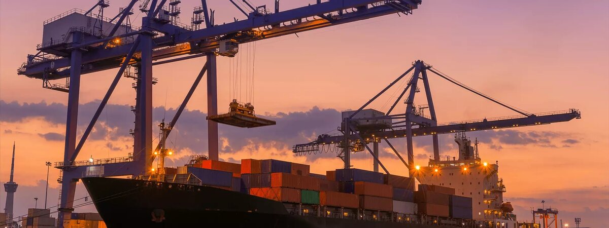 Containership in port at sunset