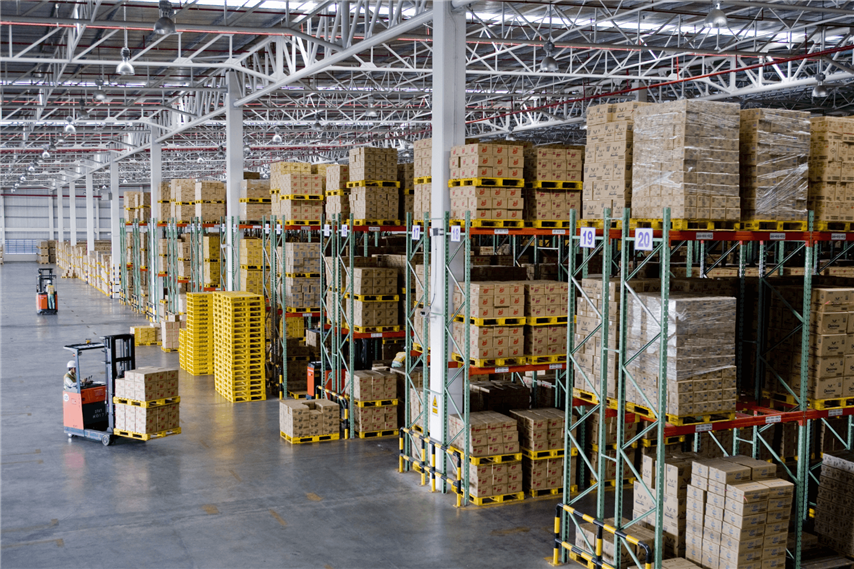 Warehouse with stacked boxes and pallet truck drivers