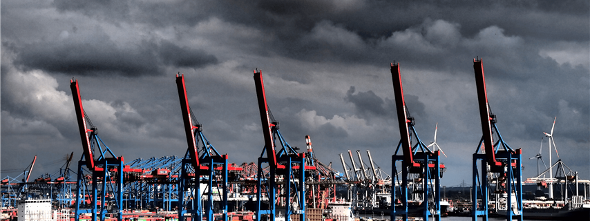 dark clouds loom over a port with cranes_s