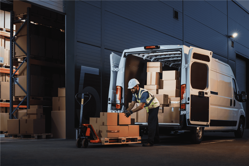 Worker Unloads Cargo From Van At Warehouse At Night Web